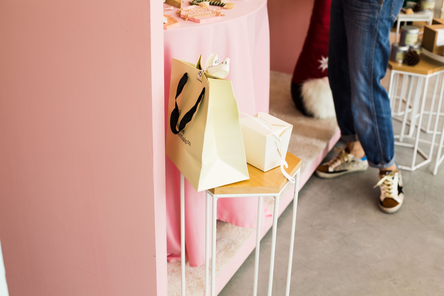 Display of paper bags against a pink wall